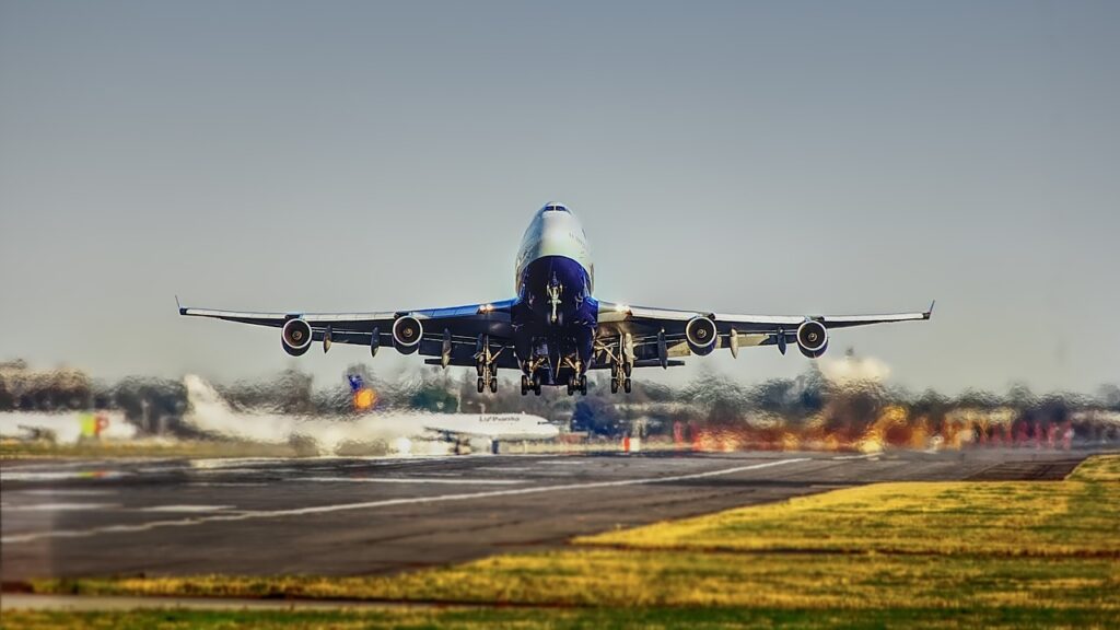 Big passenger airplane with four engines and an upper deck.